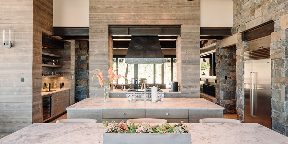 A textured marble countertop provides a generous surface for food prep and dining. Big Sky