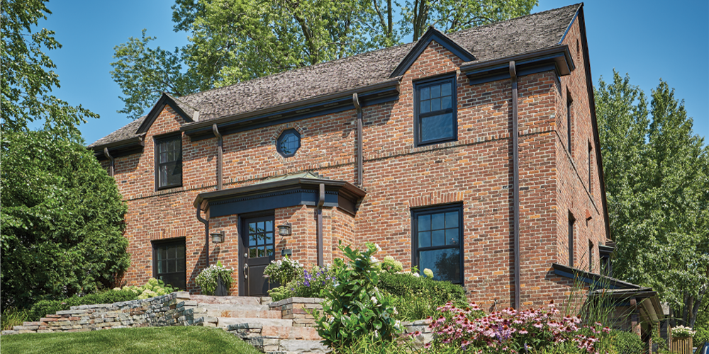 Forgent® Series double hungs 7/8" wide performance divided lite bars in top sash of double hungs Glastra® exterior in Midnight color