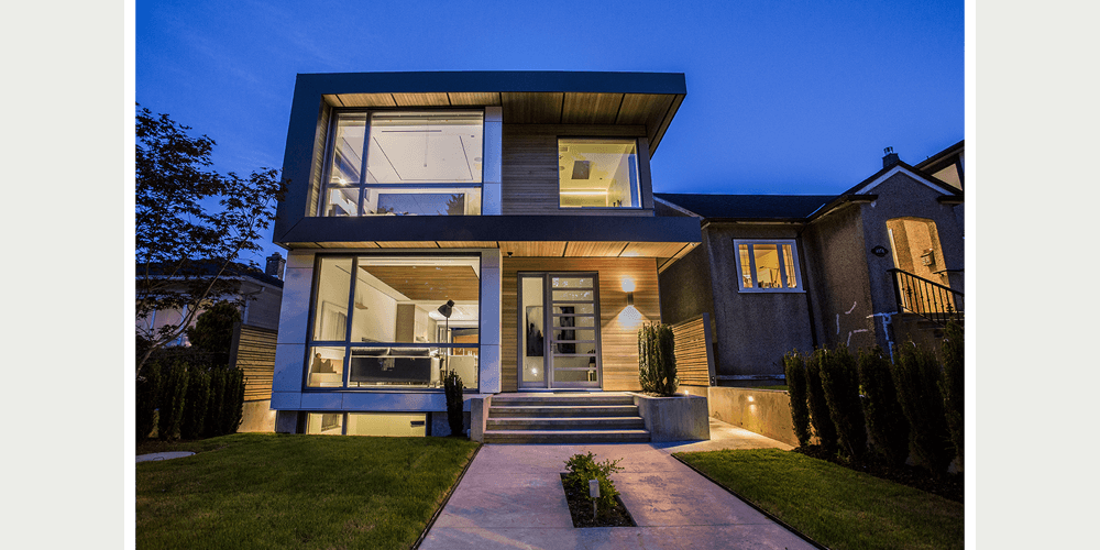 A modern two-story infill home immerses itself in the landscape, with a flat roof and linear design.